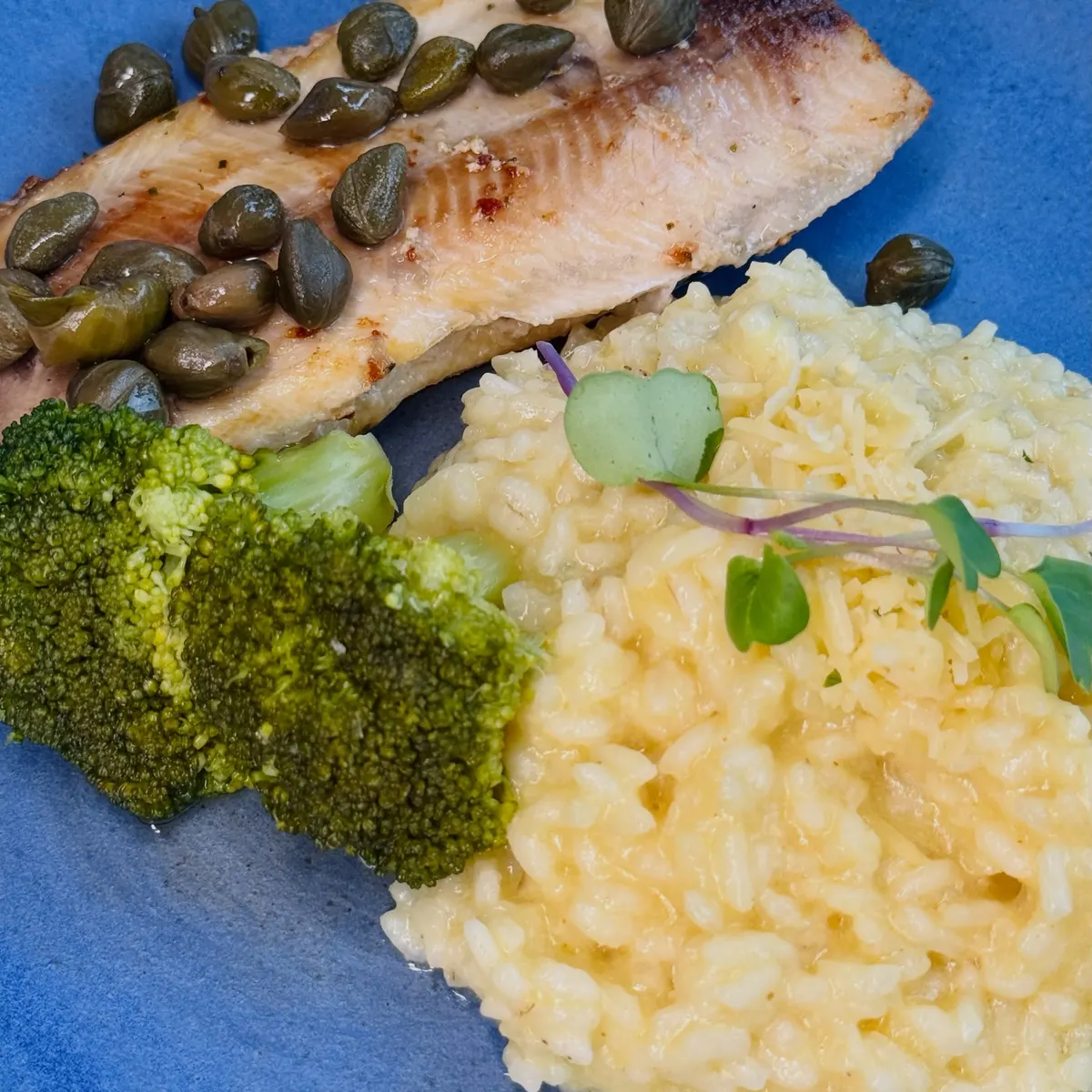 Truta com alcaparras, risoto e brócolis.